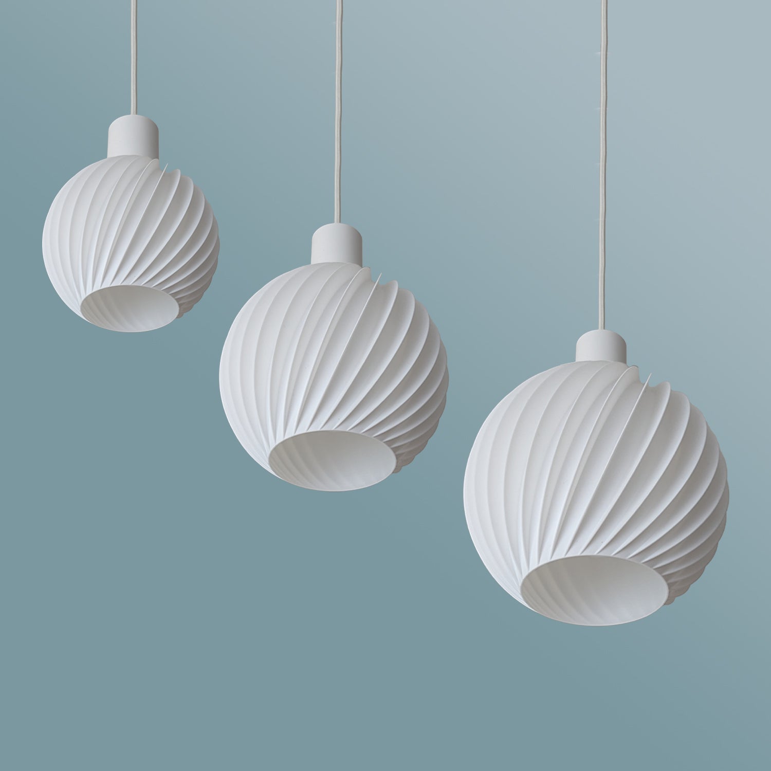 Ball Twist by Martin Žampach | Leuchte LED Pendelleuchte - 3er Set vor blauem Hintergrund